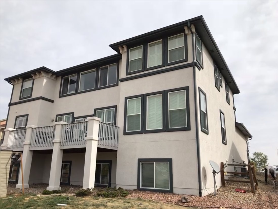 Same home after fresh stucco paint and new dark trim by M-G Painting