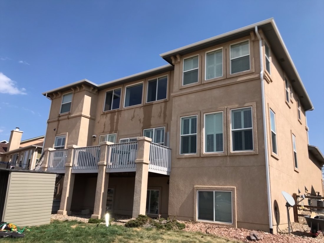 Home exterior with faded paint and worn trim, before M-G Painting