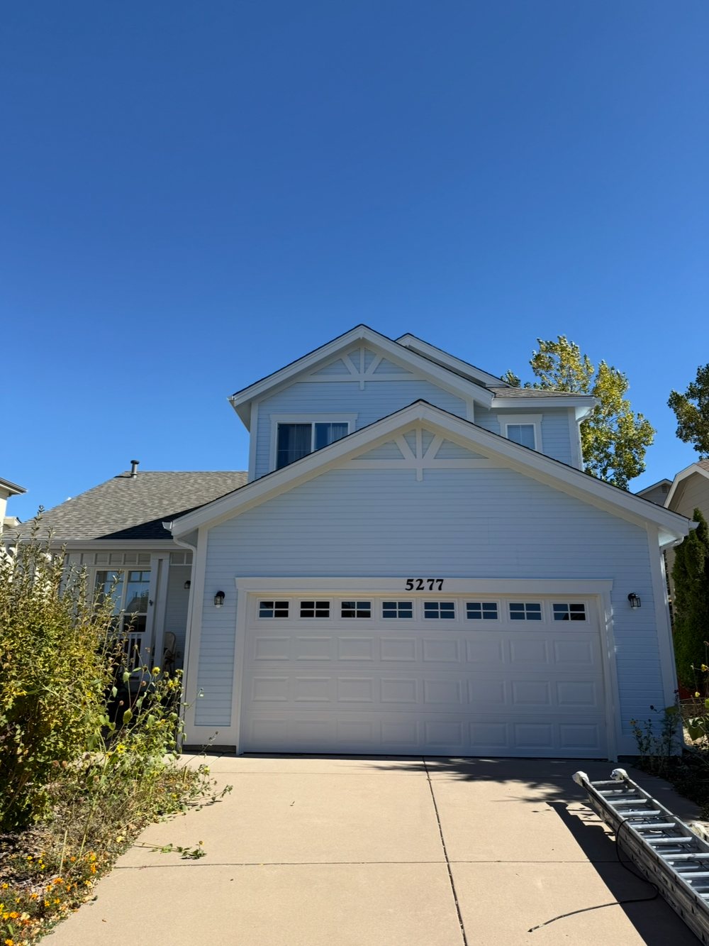 Blue two-story home exterior painting