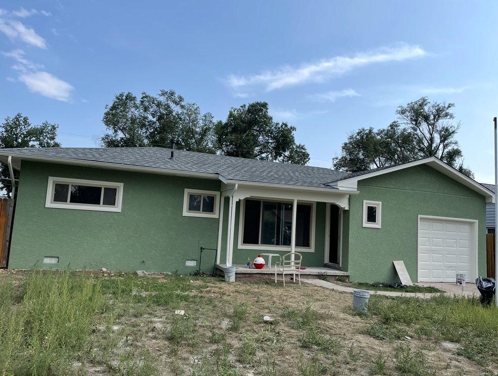 Green single-story home repaint
